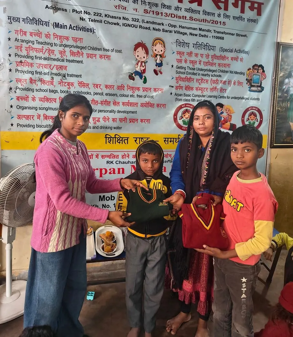 Children receiving warm sweaters from volunteers