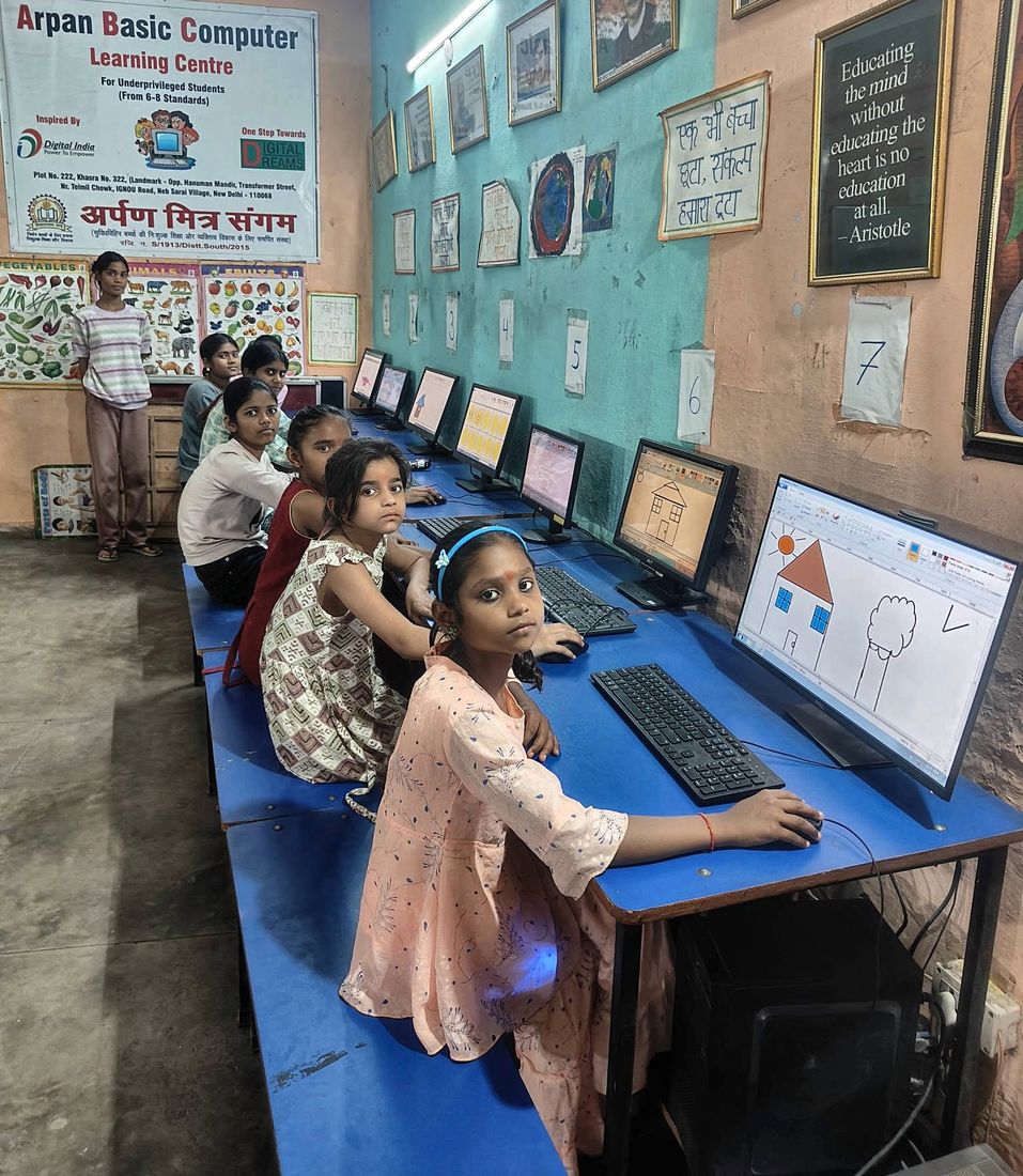 Girls learning on computers at the Arpan Basic Computer Learning Centre