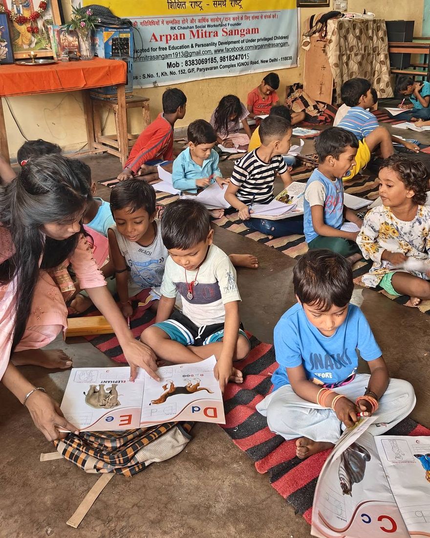 Children studying with their books on the floor of the centre