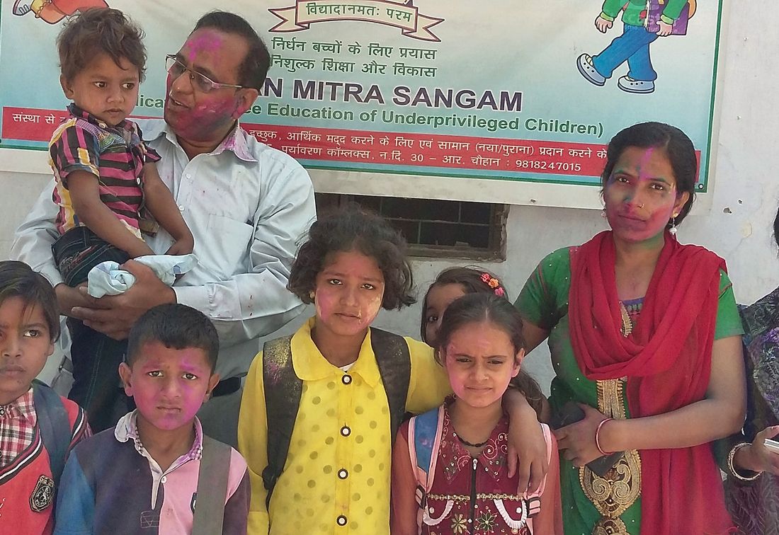 Families and children gathered at the Arpan Mitra Sangam banner