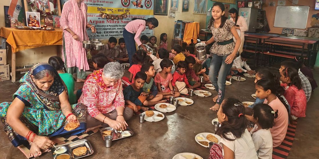 Volunteers serving a meal to children