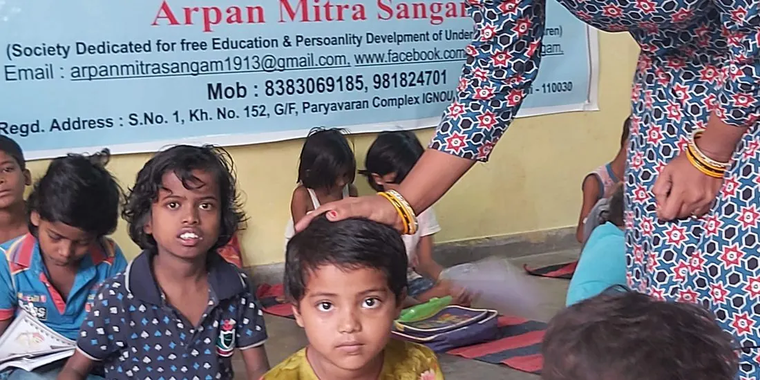 A teacher guiding children at a free class on the mats