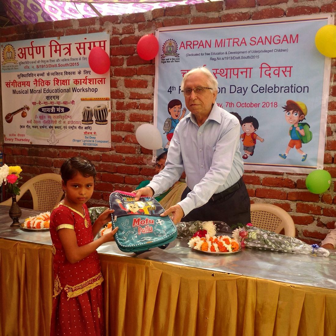 A girl receiving a gift at the Foundation Day celebration