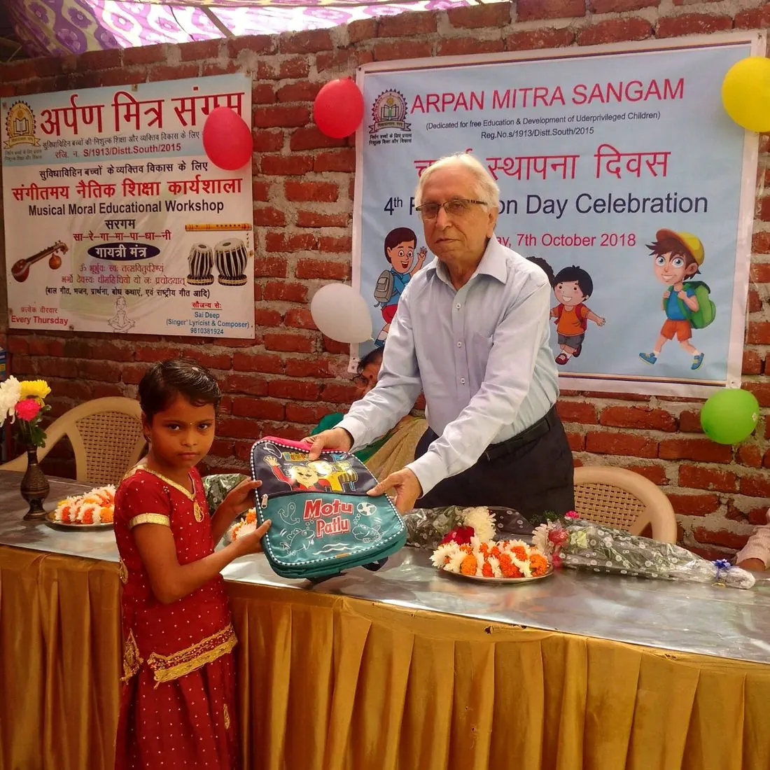 A girl receiving a gift at the Foundation Day celebration